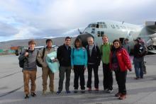 American group steps onto the tarmac, jet-lagged but smiling!