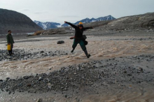 Liz jumps over the stream