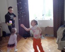 Dasha and Katya dance to the music of a bubble machine, a gift from a scientist.