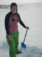 Molly working on digging a snow pit in the water track