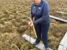 Melissa Lau measuring thaw depth