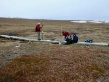 Toolik's GIS/RS team preparing the drone for take off.