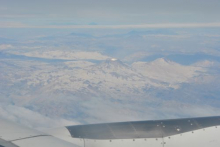 The mountainous terrain as seen from my airplane window