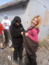 Agnes (US) helps Group 4's Sydney (US) into the waders to collect samples