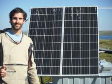 Jose with the solar panel that powers the motor for the trolley