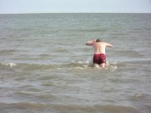 Tour guest jumping into the Arctic Ocean