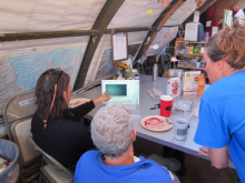 Paul looking at pictures that the divers have uploaded to a computer.