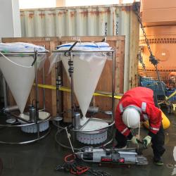 Jonaotaro Onodera (JAMSTEC) collecting samples from the sediment trap bottles.