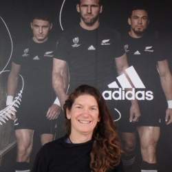 Amy Osborne in front of All Blacks sign