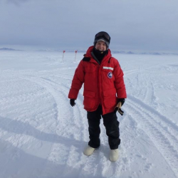 Amy Osborne standing on the sea ice in Antarctica