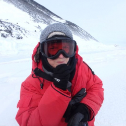 Amy Osborne eating a small sliver of sea ice.