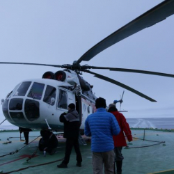 People boarding helicopter.