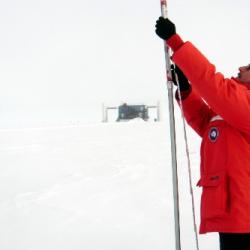 Me taking measurements of accumulated snow above an IceTop tank.