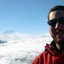 Selfie photograph with Mt. Erebus in the background.