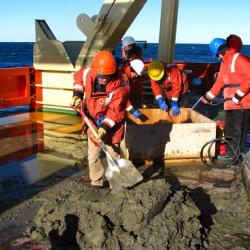 a geologic dredge being worked on , on the back deck