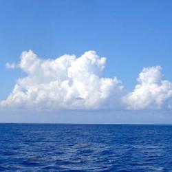 Clouds over the beautiful blue sea near where the Caribbean meets the Atlantic Ocean. 