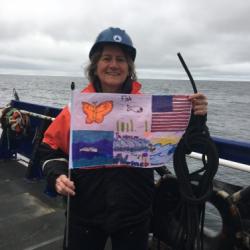 Dr. Ashjian holding an Arctic artwork flag decorated by students at the Anvil City Science Academy in Nome Alaska!  September 2, 2017.  Photo by Lisa Seff.