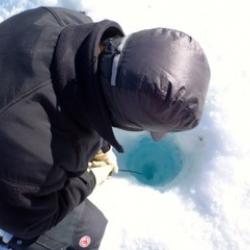 Tyler lowering a camera into the lake